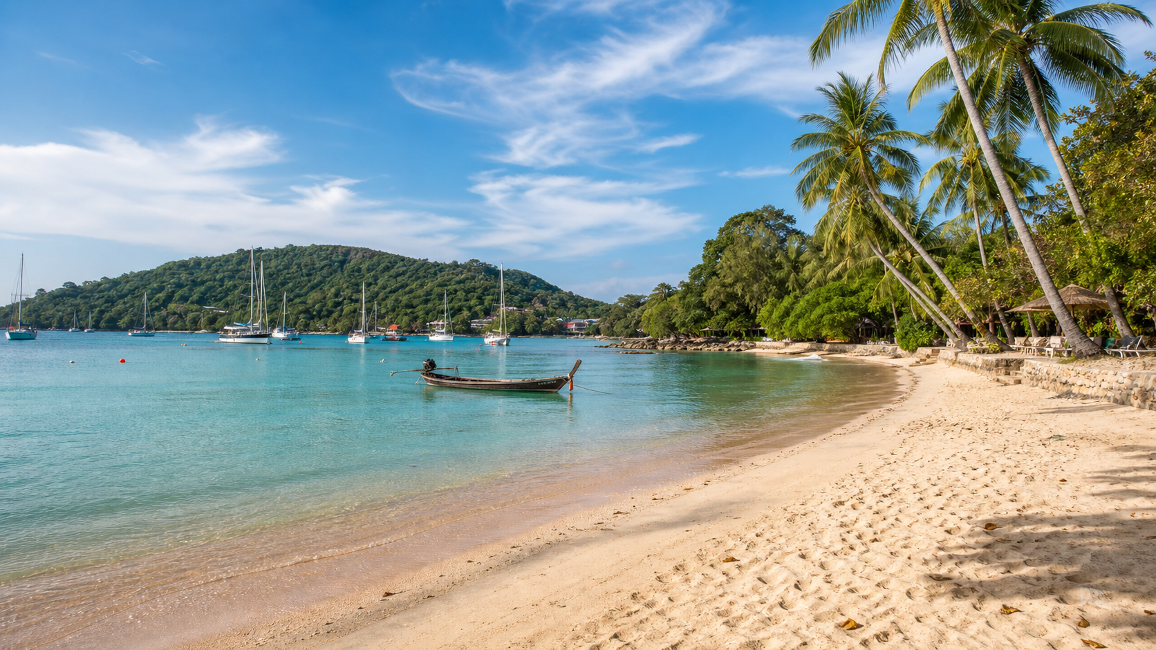 Ao Yon Beach in Phuket with calm turquoise water, palms, and Cape Panwa hills