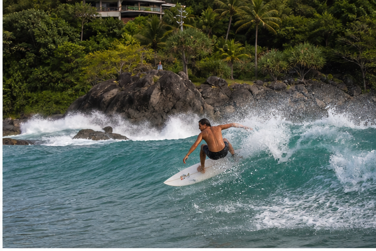 A stronger surfer carving across a faster wave near Kalim Beach in Phuket