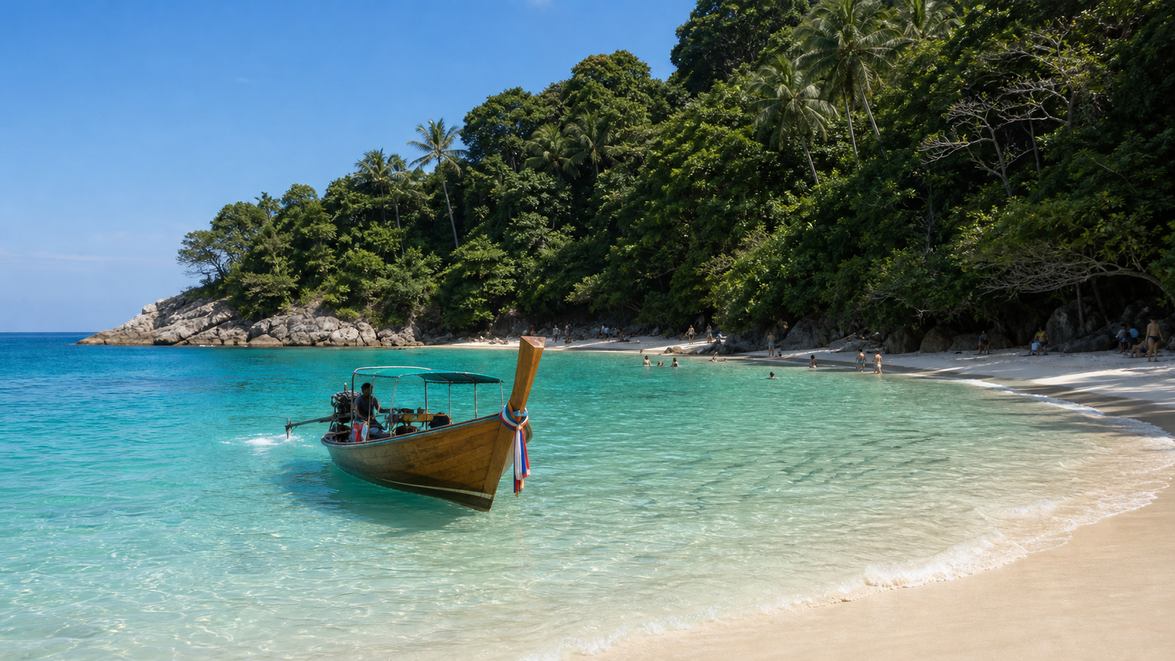 Traditional longtail boat arriving at Freedom Beach Phuket in calm high-season water