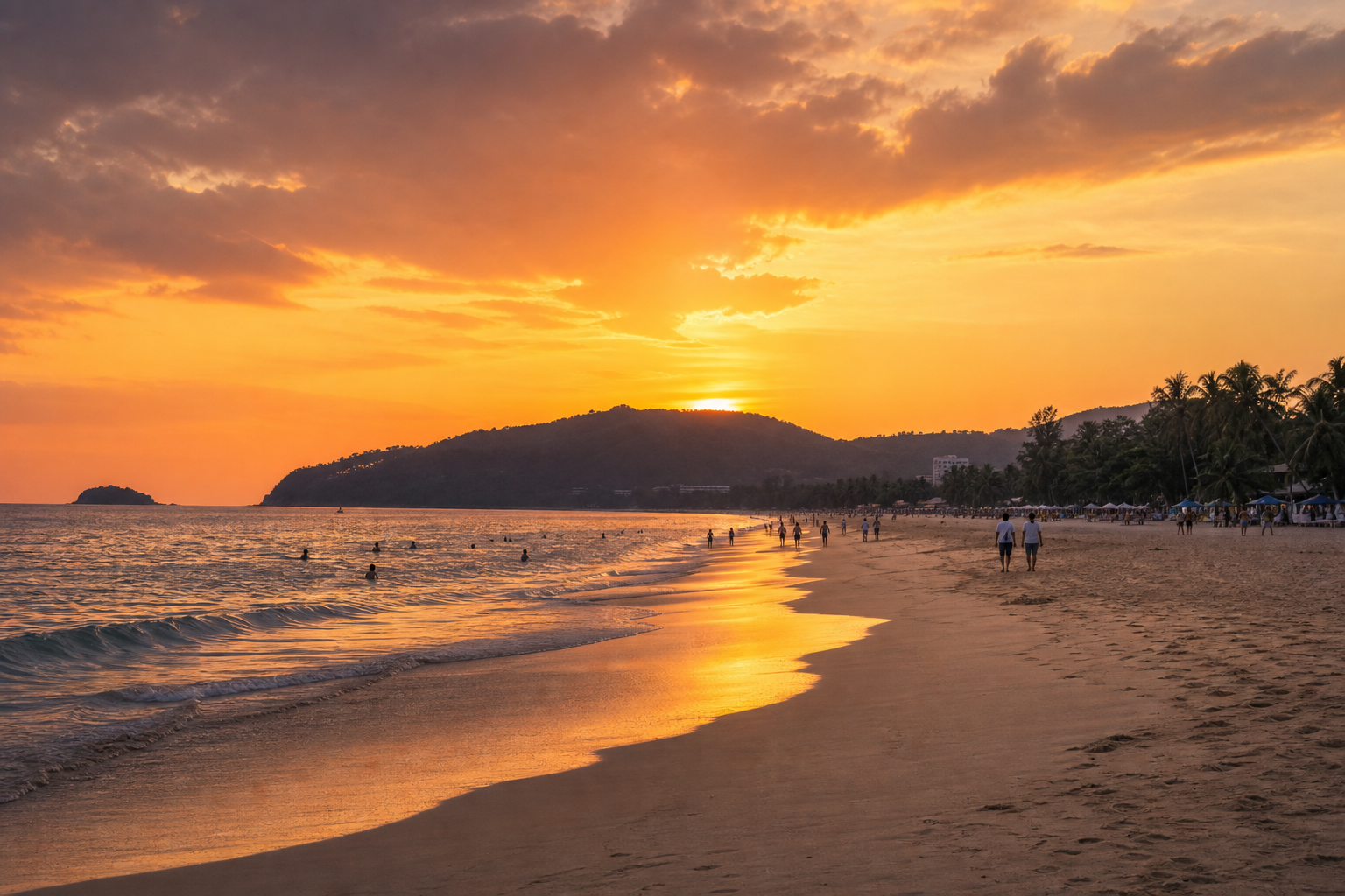 Sunset over Karon Beach in Phuket with glowing sky reflected on the shoreline