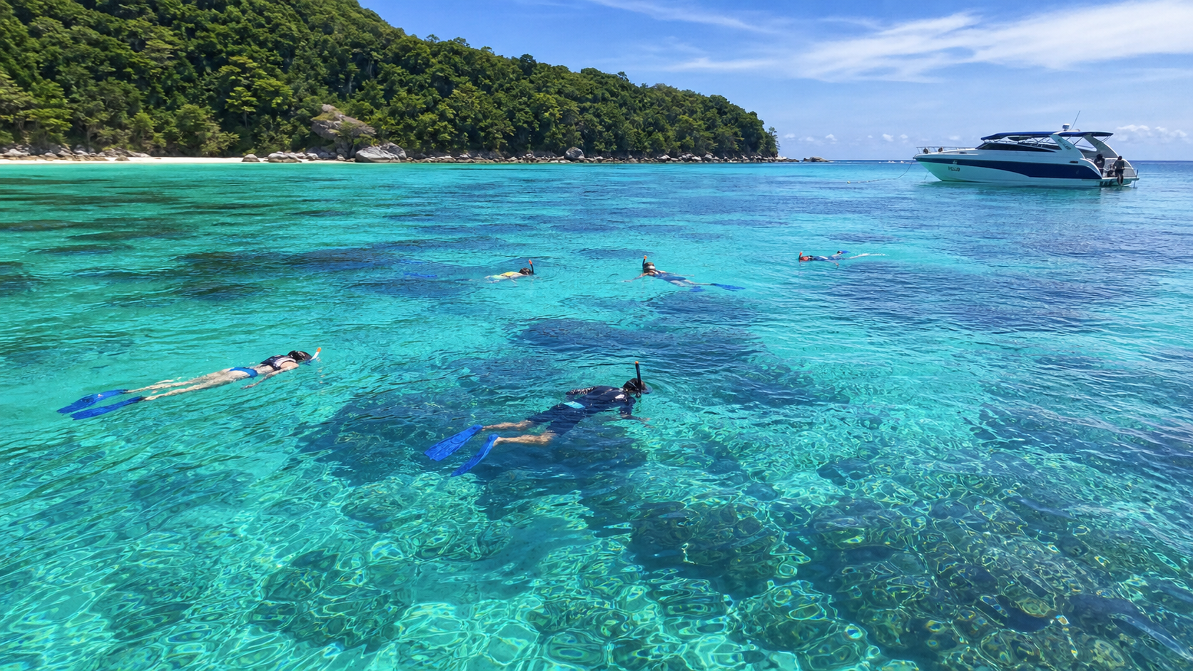 Maiton Island with blue water and a small boat offshore