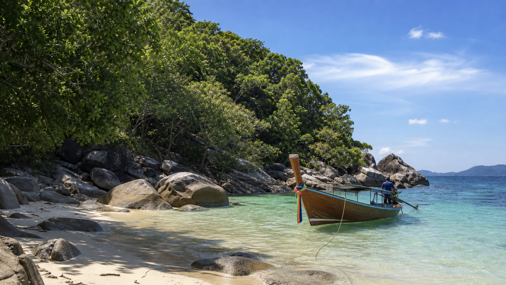 Quiet island near Phuket with turquoise water and longtail boat